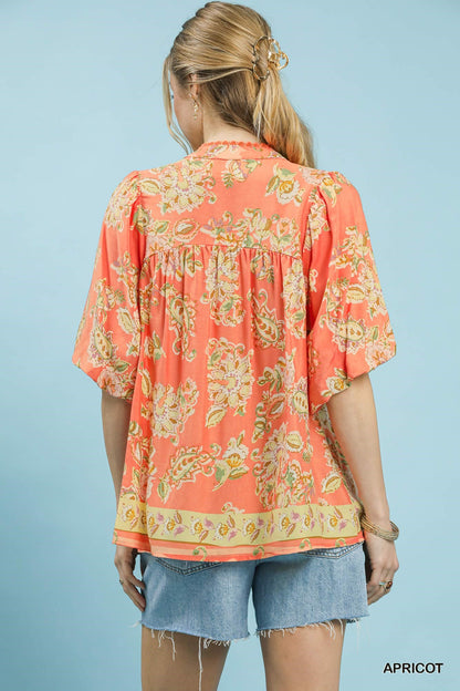 Umgee Apricot Floral Boho Blouse with long sleeves and ruffled details, featuring a vibrant apricot floral print.