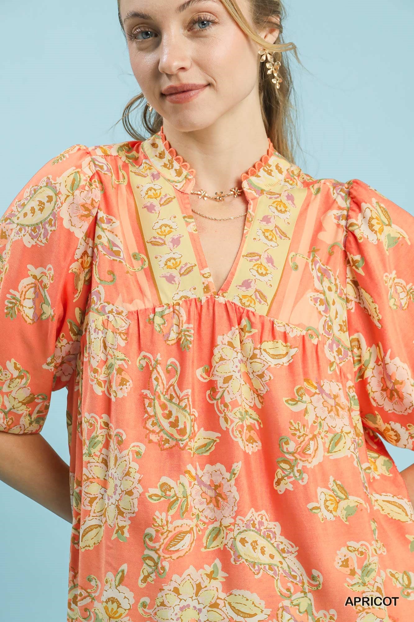 Umgee apricot floral boho blouse with long sleeves and a relaxed fit, featuring a vibrant floral pattern.