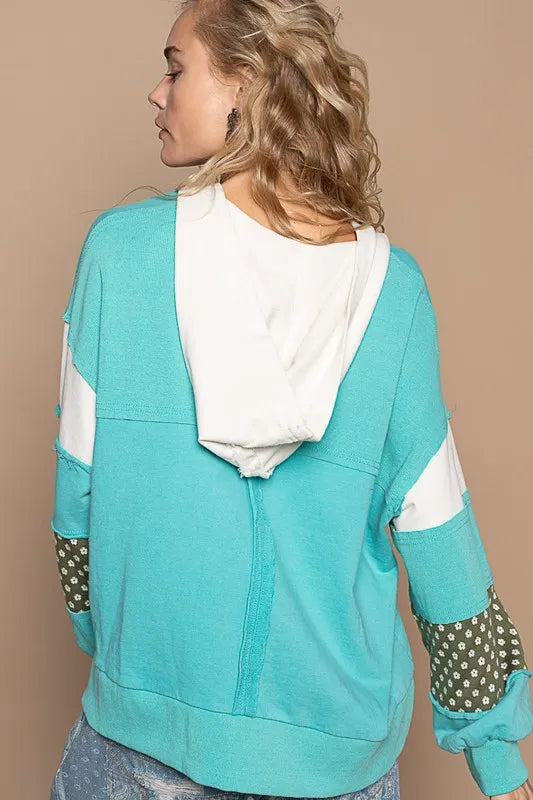 Aqua floral patchwork French Terry hoodie with exposed seams and a casual, relaxed fit, by Trendsi.