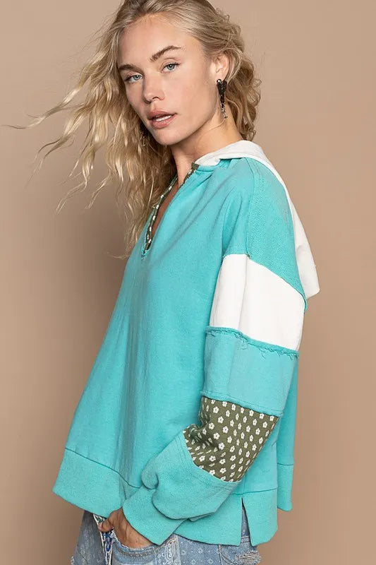 Aqua POL Trendsi floral patchwork French Terry hoodie with exposed seams and casual fit, featuring colorful floral designs and a relaxed style.