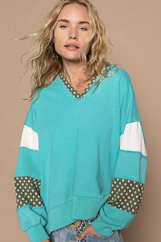 Aqua blue French terry hoodie with floral patchwork and exposed seams from Trendsi, casual and stylish for everyday wear.