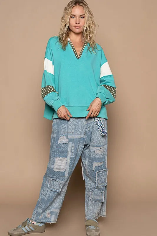 A POL floral patchwork French terry hoodie with exposed seams in aqua, featuring a casual, cozy design and floral details.