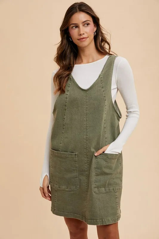 Army green Annie Wear V-neck adjustable strap denim overall dress with front pockets, featuring a casual, stylish design.