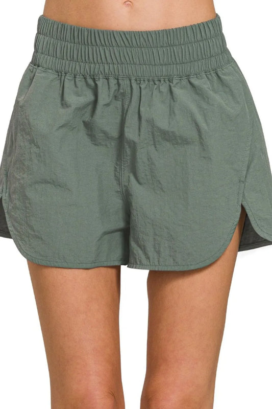 Ash jade Zenana windbreaker running shorts with smocked waistband, designed for comfortable activewear.
