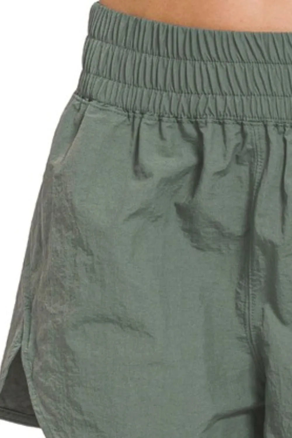 Ash jade Zenana windbreaker running shorts with smocked waistband, designed for comfort and active wear.