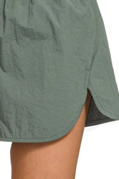 Zenana windbreaker running shorts with smocked waistband in ash jade, featuring a comfortable fit and sporty design.