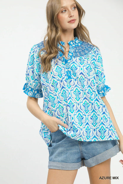Azure blue Umgee Mix Boho puff sleeve smocked top with relaxed fit and ruffled details, perfect for casual, bohemian style.