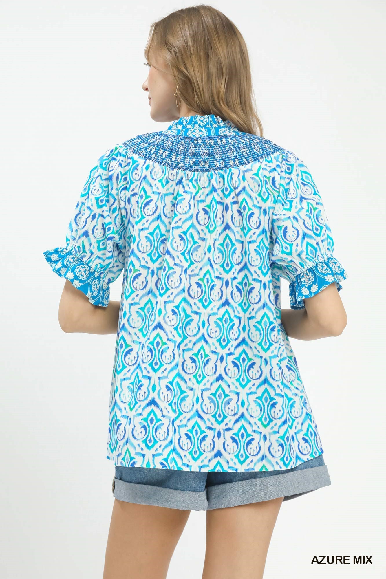 Azure blue Umgee Mix Boho puff sleeve smocked top with ruffled details and relaxed fit, perfect for casual and bohemian styles.