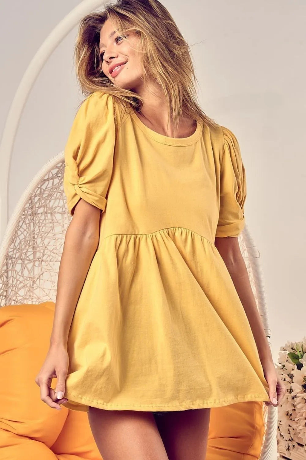 Trendi's BiBi Cotton Span Knit Baby Doll Top with puff sleeves, soft knit fabric, and feminine fit for stylish casual wear.