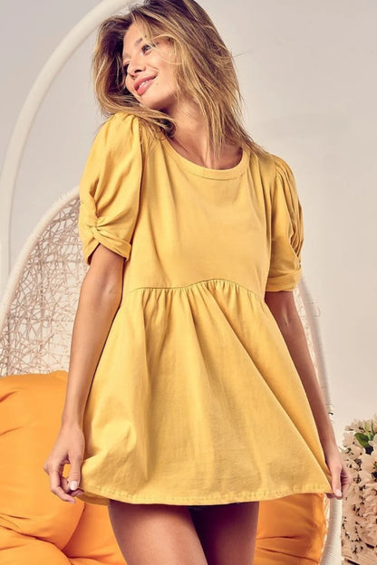 Trendi's BiBi Cotton Span Knit Baby Doll Top with puff sleeves, soft knit fabric, and feminine fit for stylish casual wear.