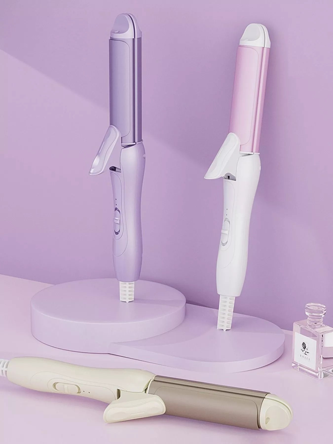 Beige 2-in-1 rotating hair curling iron by Trendsi with European plug, showcasing its sleek design and rotating barrel.