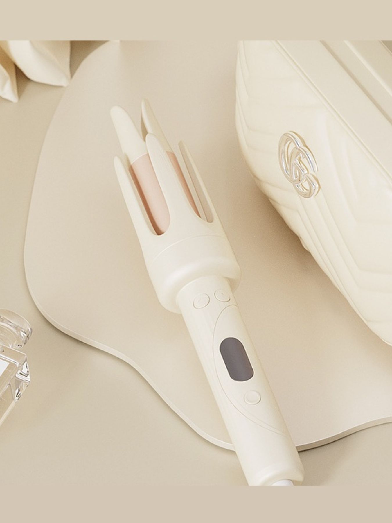 Beige automatic hair curling iron by Trendsi with European plug, showing the curling barrel and handle in a close-up shot.