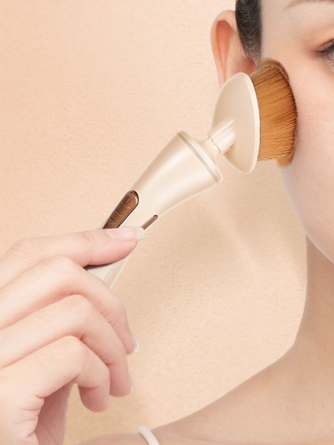 Beige electric makeup brush by Trendsi with a sleek design, perfect for applying foundation and blending makeup seamlessly.