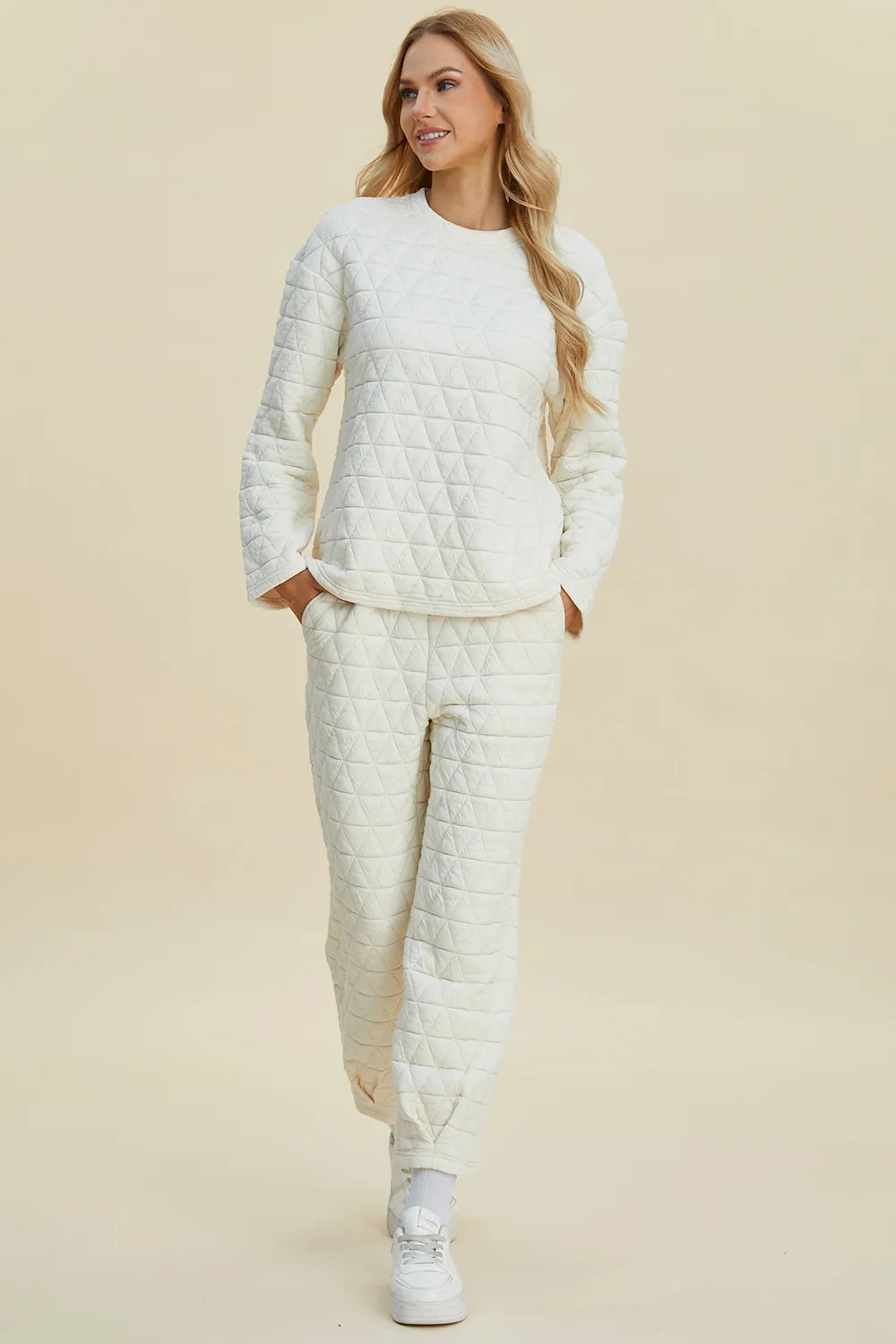 Beige Trendsi Double Take full-size textured round neck long sleeve top and matching pants set on a model.