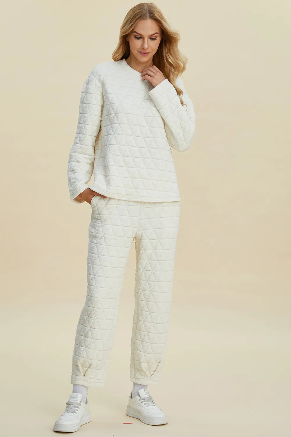Beige Trendsi Double Take full size textured round neck long sleeve top and matching pants set on a model.