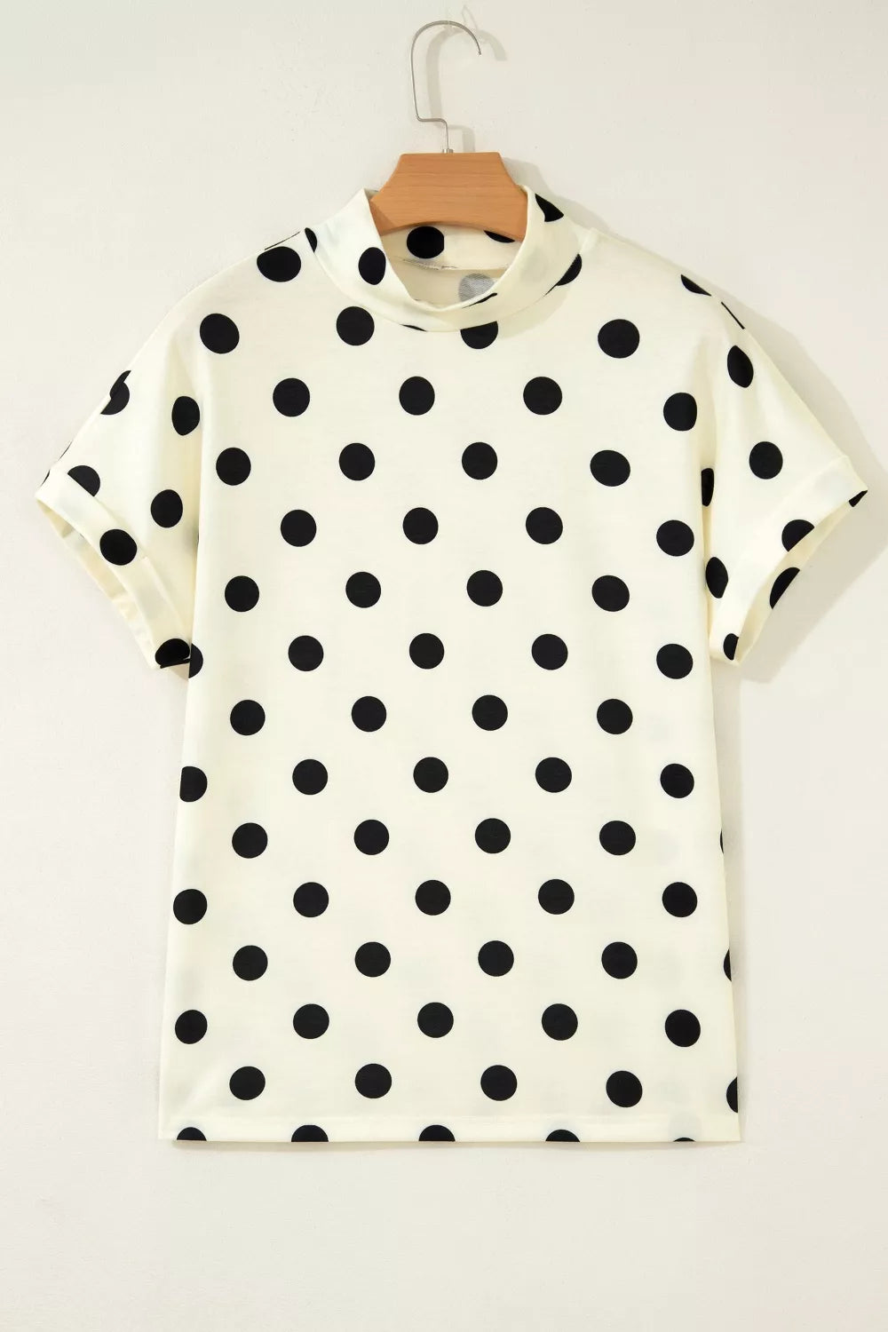 Beige polka dot mock neck short sleeve blouse by Trendsi, featuring a stylish casual top with a classic polka dot pattern.