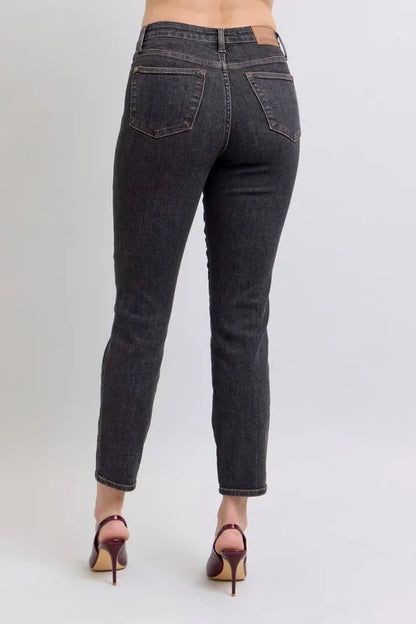 Trendy Judy Blue full size mid-rise tummy control slim jeans in plus size, showcasing a comfortable fit and classic denim style.