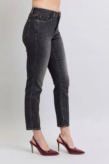Plus size Judy Blue mid-rise slim jeans featuring tummy control and a full size fit, shown on a model.