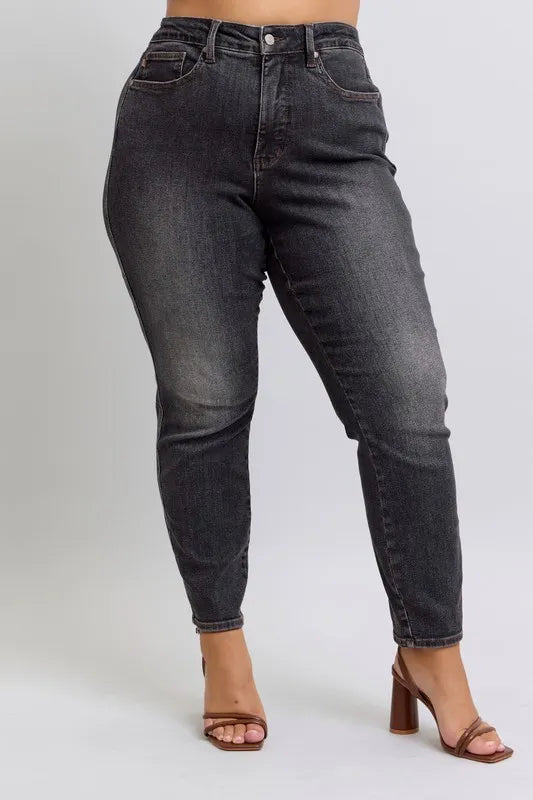 Plus size Judy Blue mid-rise slim jeans with tummy control, designed for full-figure fit and comfort.