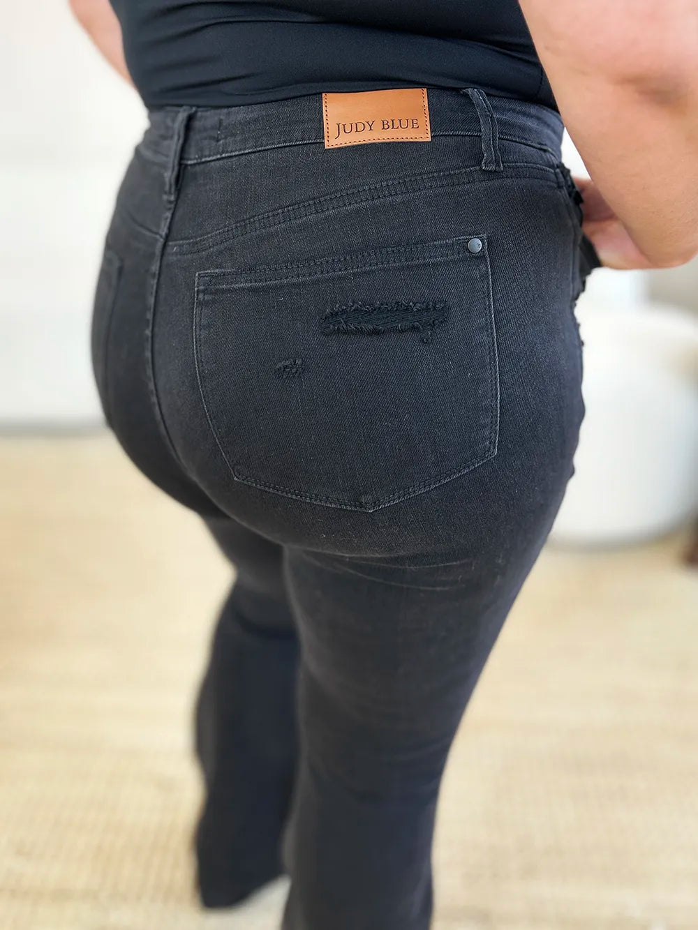 Black Judy Blue high waist distressed flare jeans featuring a full-length design and trendy ripped details.