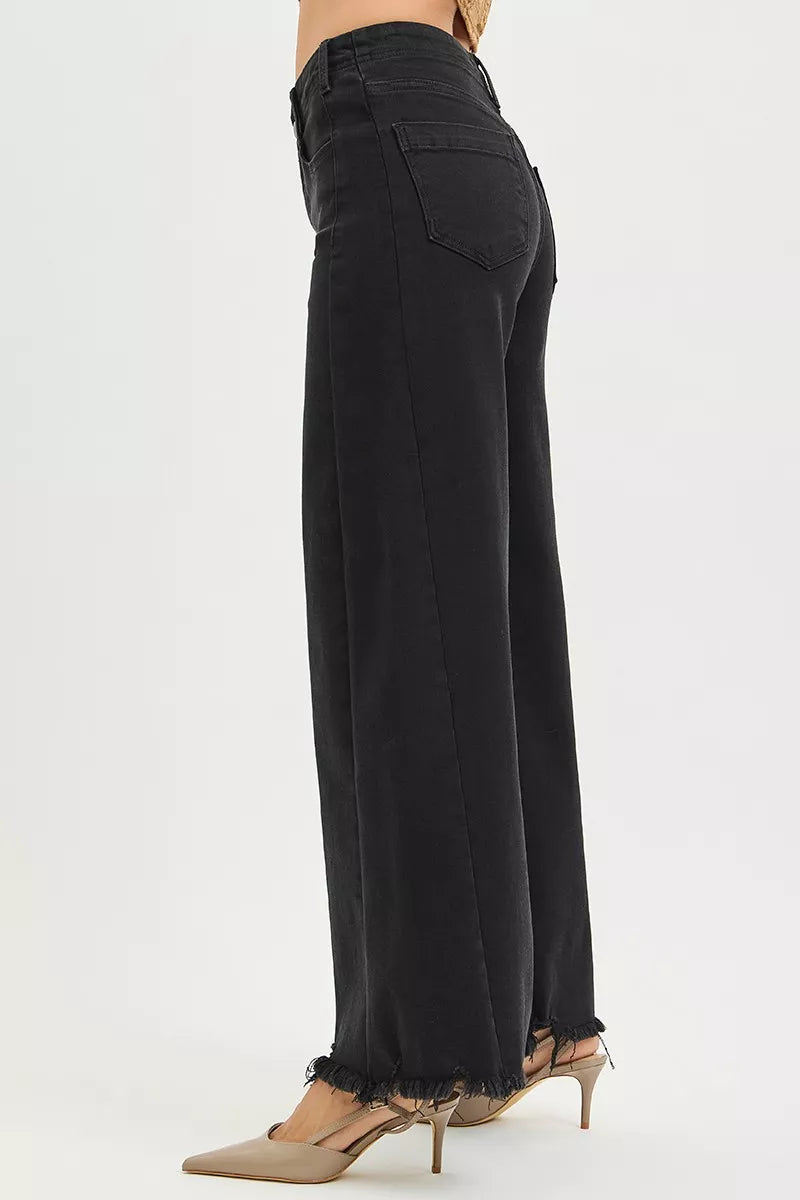 Black RISEN high-rise palazzo jeans with tummy control and frayed hem, featuring a relaxed fit and stylish design.