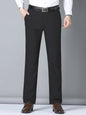 Men's black slim fit casual pants by Trendsi, featuring a tailored design and comfortable fit, shown on a model.