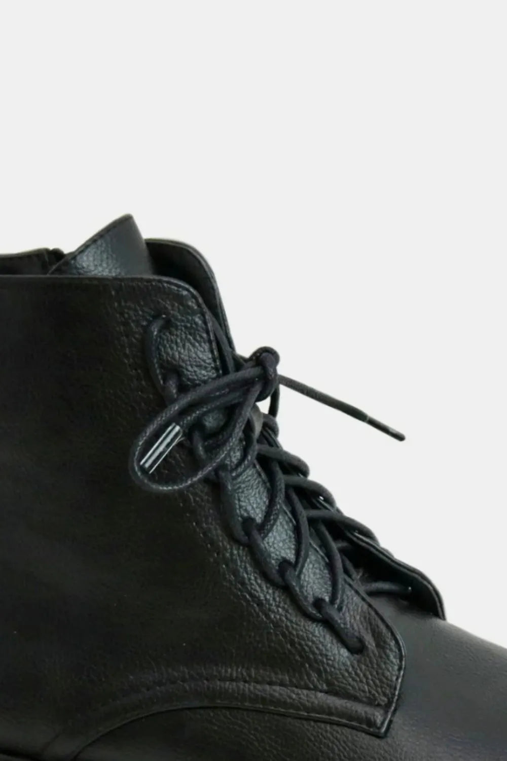 Black faux leather lace-up boots with side zipper from Beast Fashion by Trendsi, showcasing stylish design and sturdy construction.