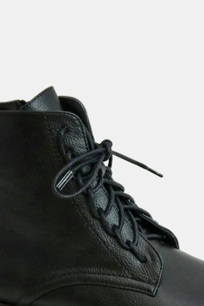 Black faux leather lace-up boots with side zipper from Beast Fashion by Trendsi, showcasing stylish design and sturdy construction.