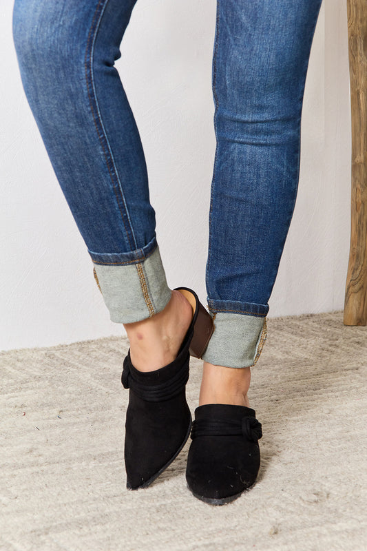 Black East Lion Corp pointed-toe braided trim mules with sleek design, featuring a stylish braided detail on the upper.
