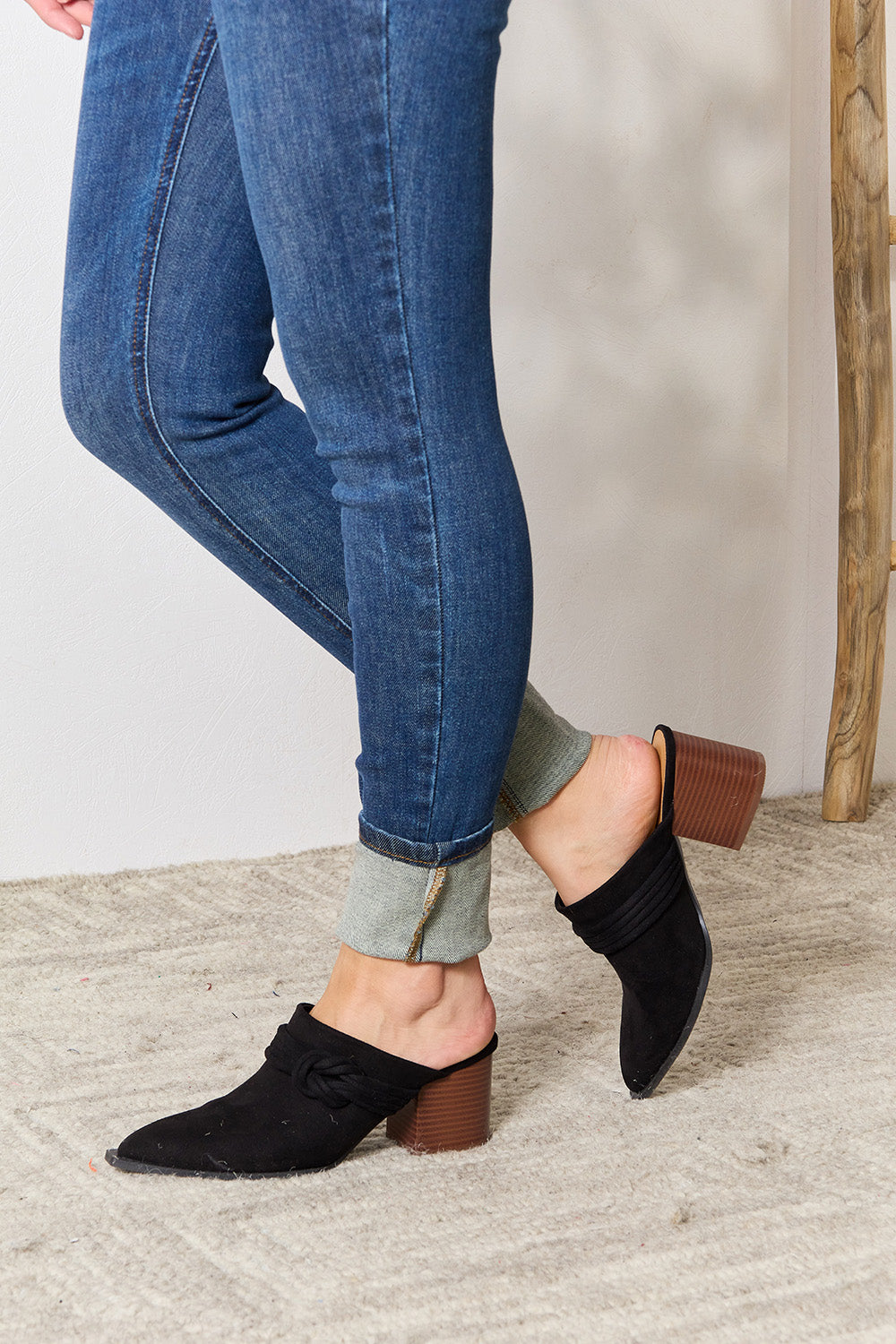 Black East Lion Corp pointed-toe braided trim mules with sleek design and low heel, perfect for stylish, comfortable footwear.