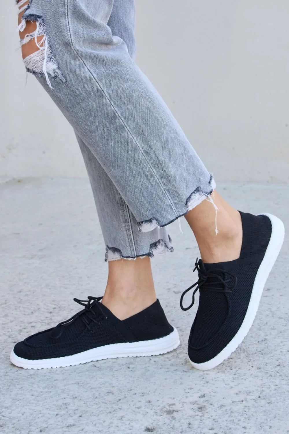 Black Forever Link flat round toe lace-up sneakers by Trendsi with a sleek design and comfortable fit.