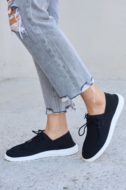 Black Forever Link flat round toe lace-up sneakers by Trendsi with a sleek design and comfortable fit.