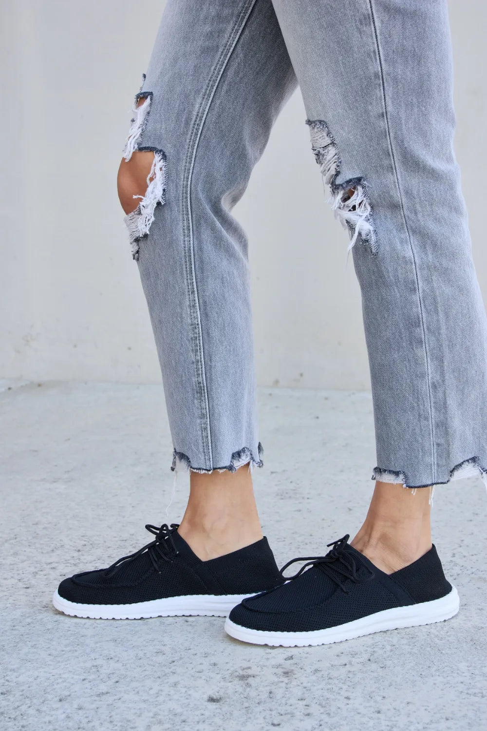 Black Trendi Forever Link flat round toe lace-up sneakers with white sole and stylish design, perfect for casual wear.