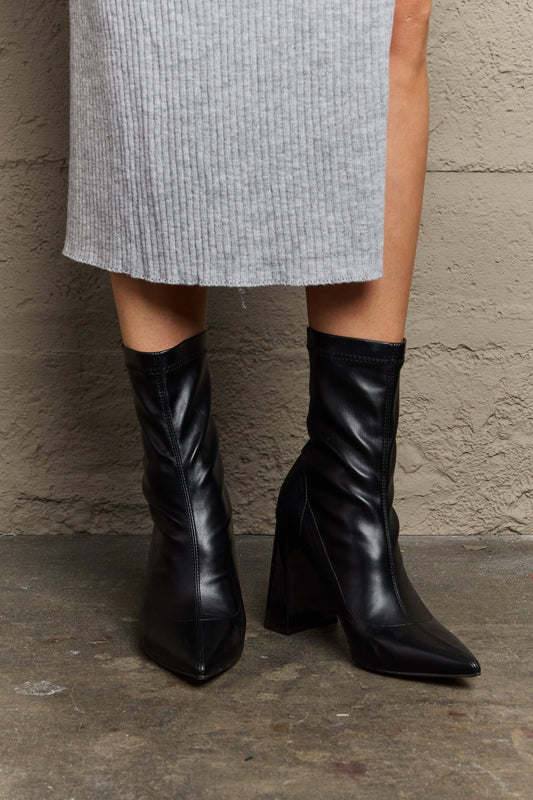 Black Weeboo Stacy block heel sock boots by Trendsi, featuring a sleek design and snug fit with a stylish block heel.
