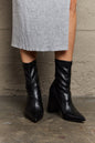 Black Weeboo Stacy block heel sock boots by Trendsi, featuring a sleek design and snug fit with a stylish block heel.
