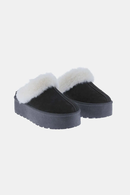 Black Weeboo snow slippers with thick soles and fur trim, designed for warmth and comfort in winter weather.