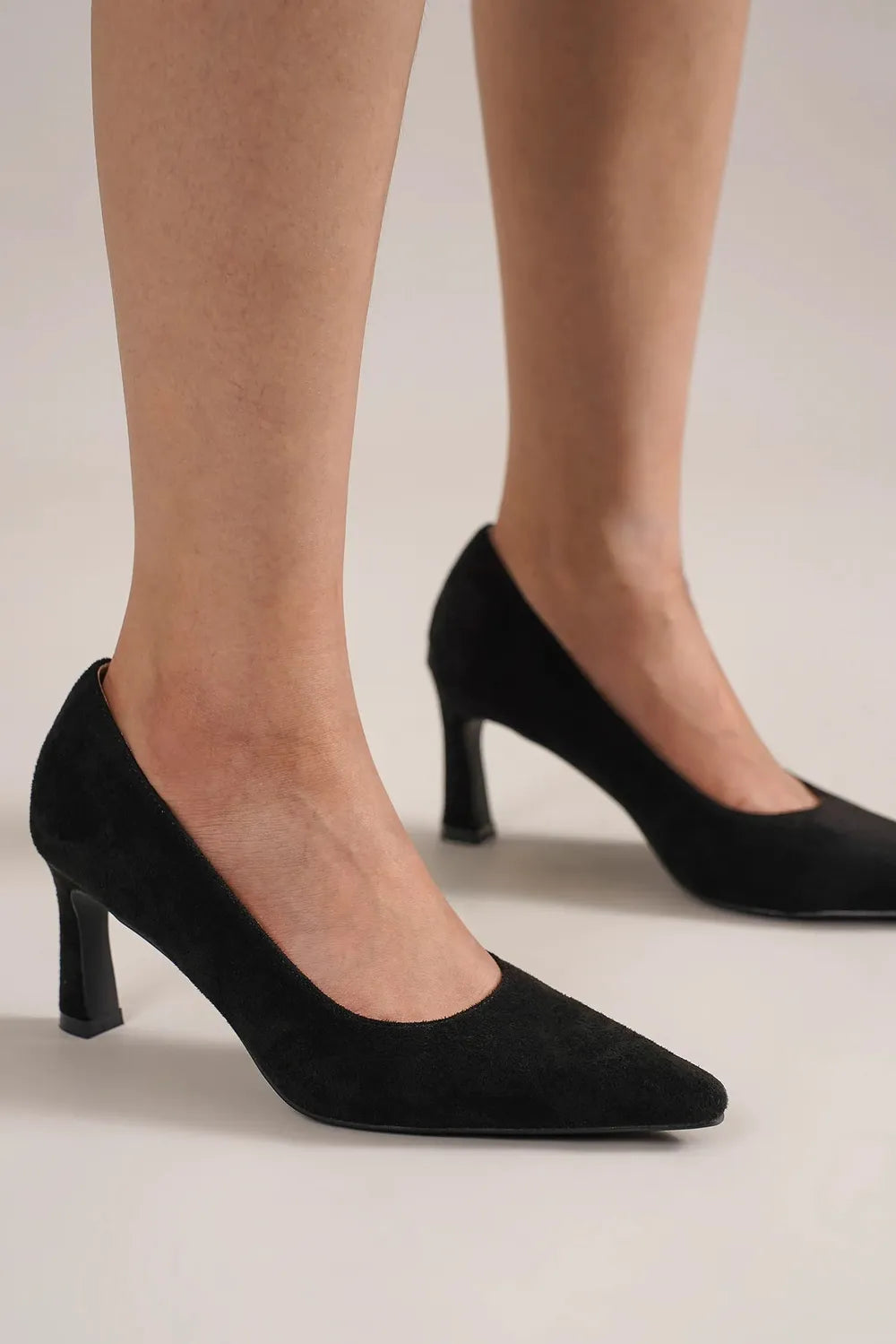 Black faux suede point toe pumps by Beast Fashion, stylish women's dress shoes with a sleek, pointed toe design.