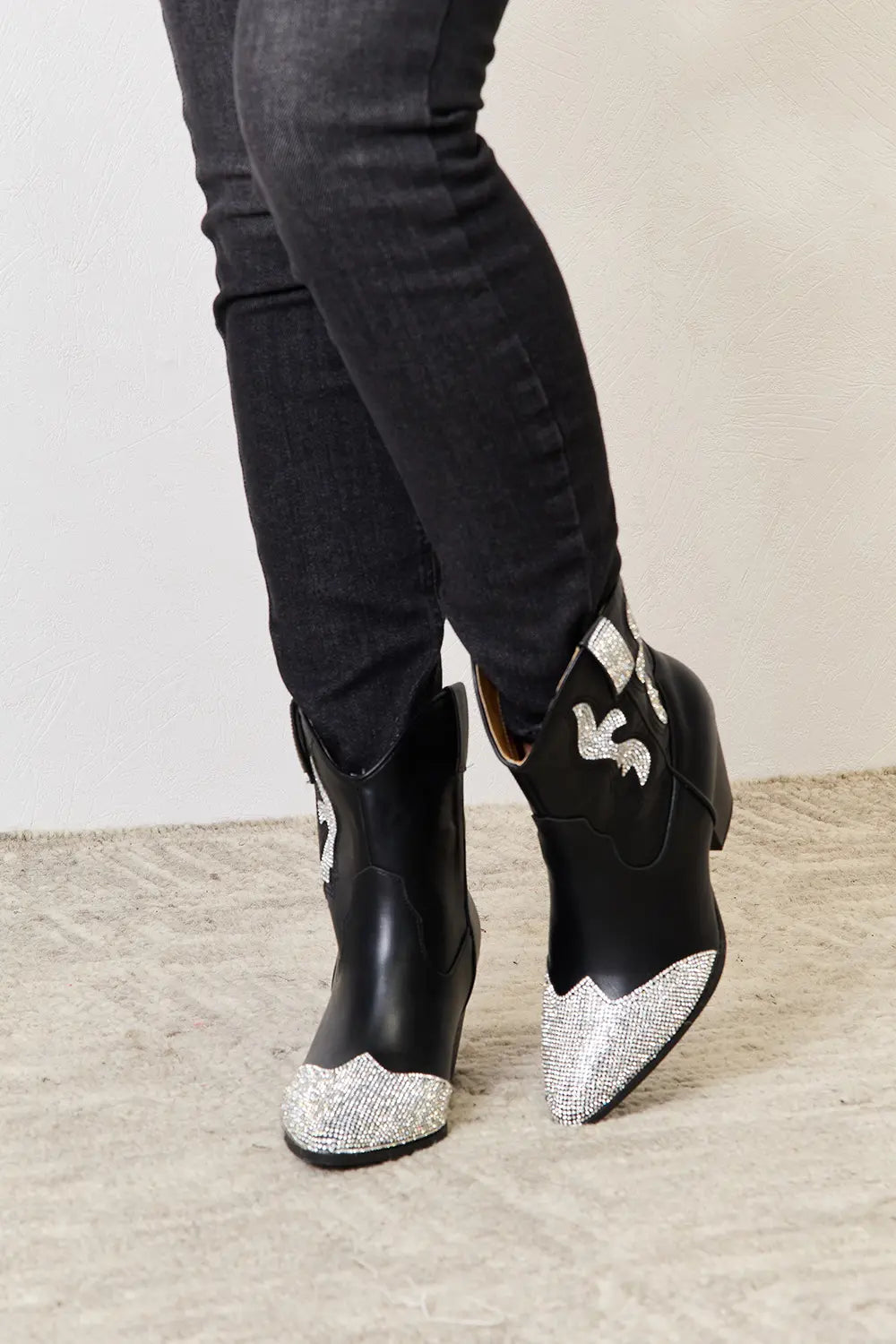 Black East Lion Corp rhinestone pointed boots with stiletto heels and decorative rhinestone details, stylish footwear by Trendsi.