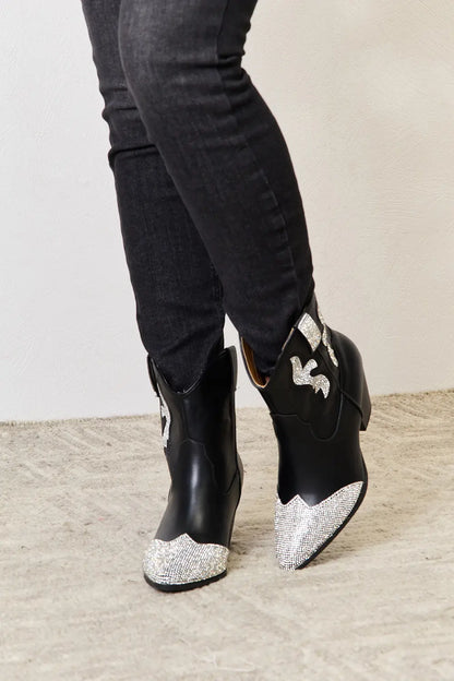 Black East Lion Corp rhinestone pointed boots with stiletto heels and decorative rhinestone details, stylish footwear by Trendsi.