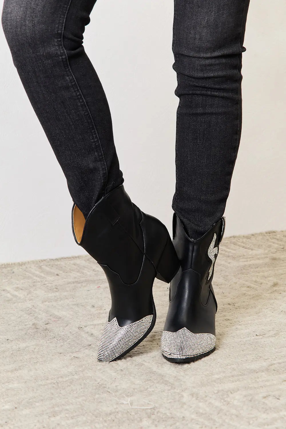 Black rhinestone pointed boots by East Lion Corp featuring a sleek design and decorative rhinestones, perfect for stylish outfits.