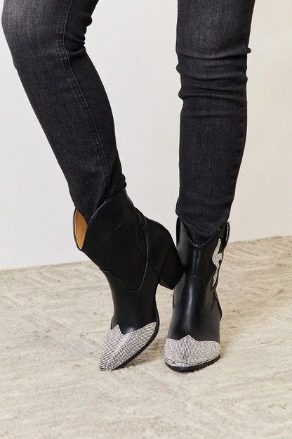 Black rhinestone pointed boots by East Lion Corp featuring a sleek design and decorative rhinestones, perfect for stylish outfits.