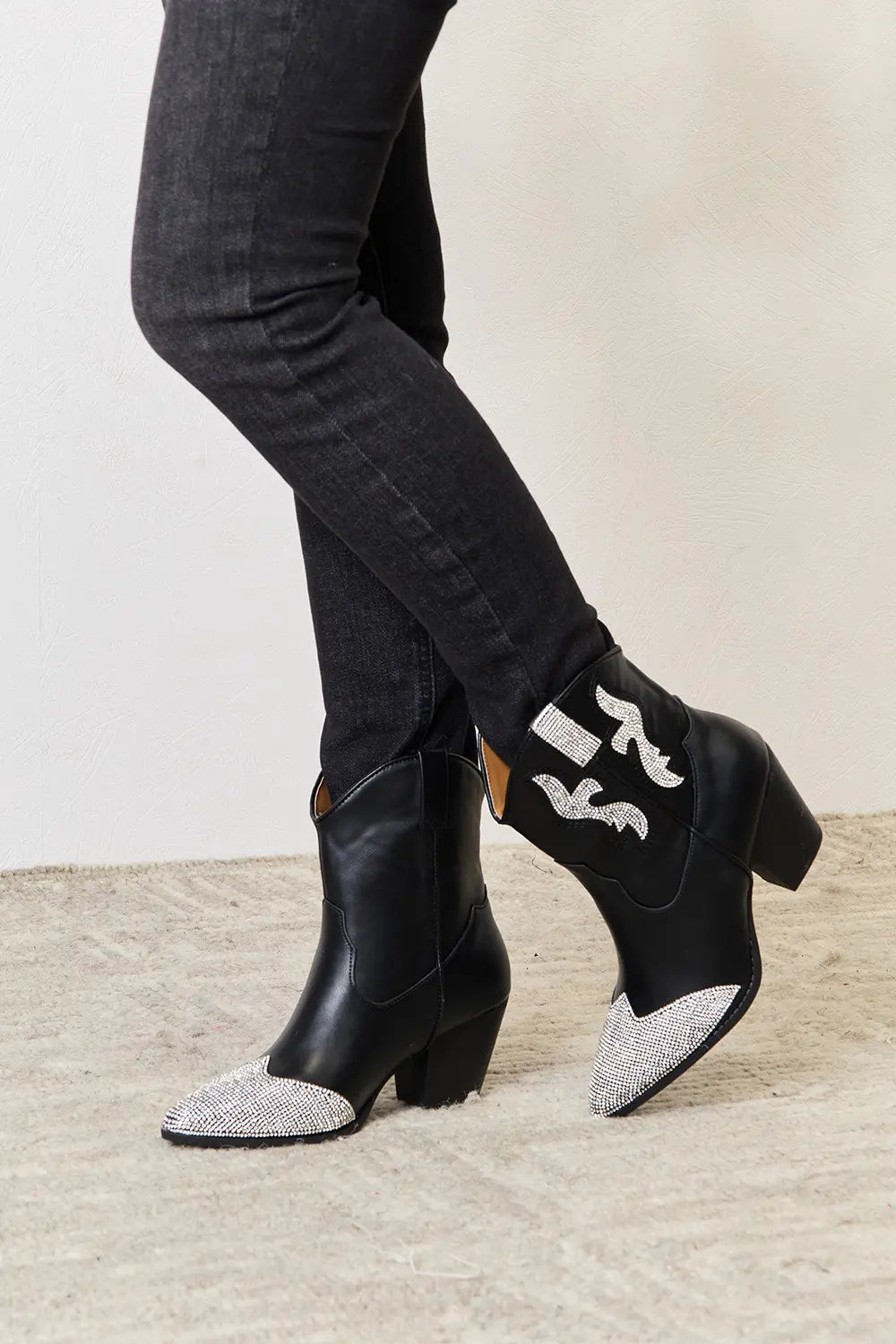 Black rhinestone pointed boots from East Lion Corp by Trendsi, featuring a sleek design and sparkling embellishments.