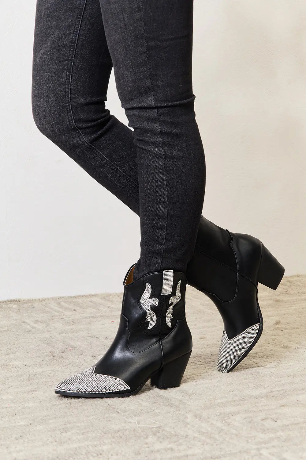 Black rhinestone pointed boots from East Lion Corp by Trendsi, featuring a sleek design with sparkling embellishments.