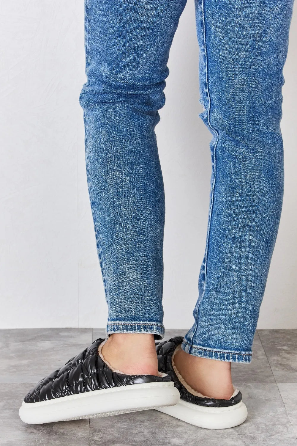 Black Melody Puffer Plush Slippers by Trendsi featuring a cozy, quilted design and soft plush material for comfortable indoor wear.