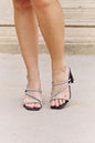 Black Qupid Level Up Rhinestone Strap Heels with glittering rhinestone details and ankle strap for stylish elegance.