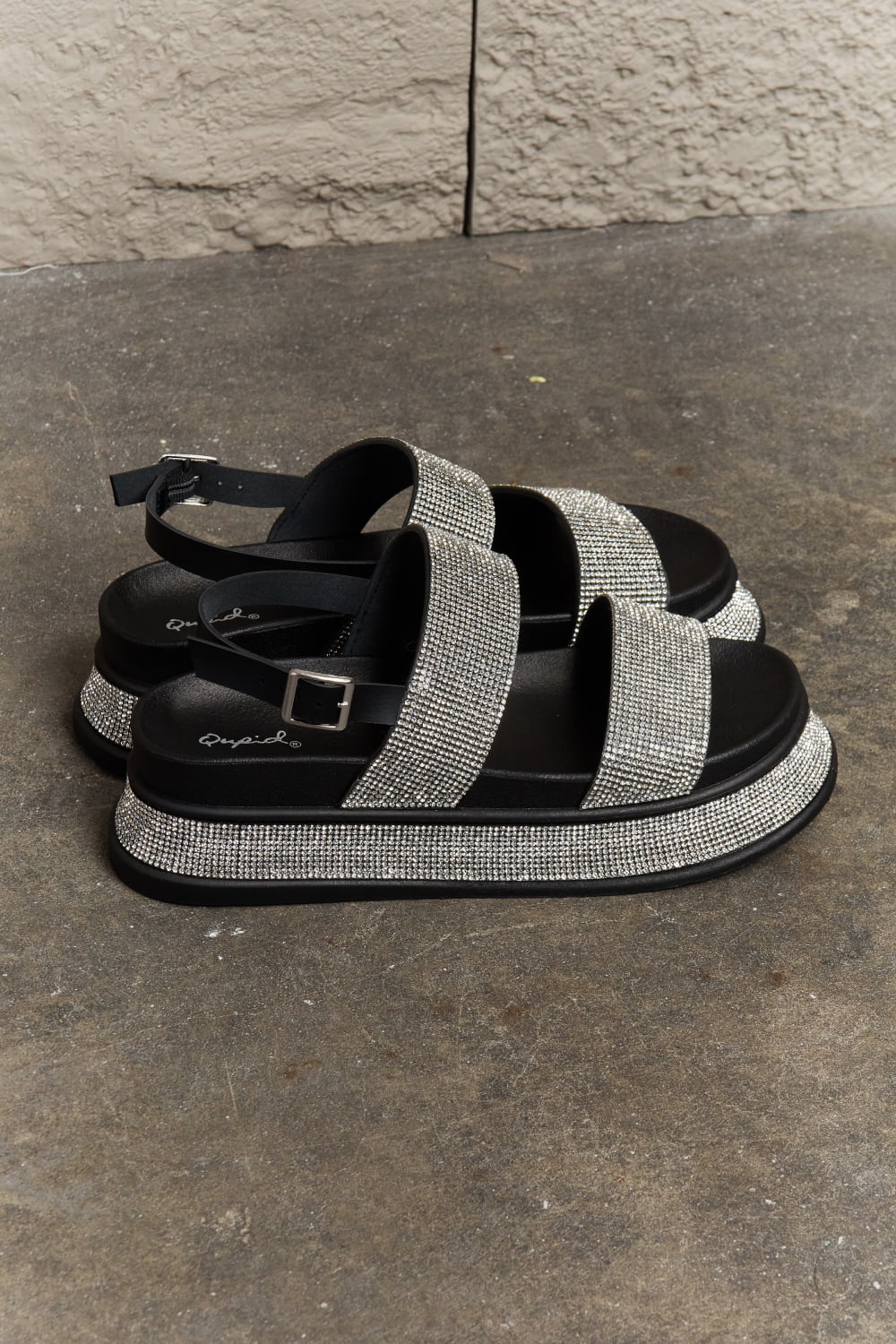 Black Qupid Shine On platform rhinestone slingback sandal with sparkling embellishments and a chunky heel.