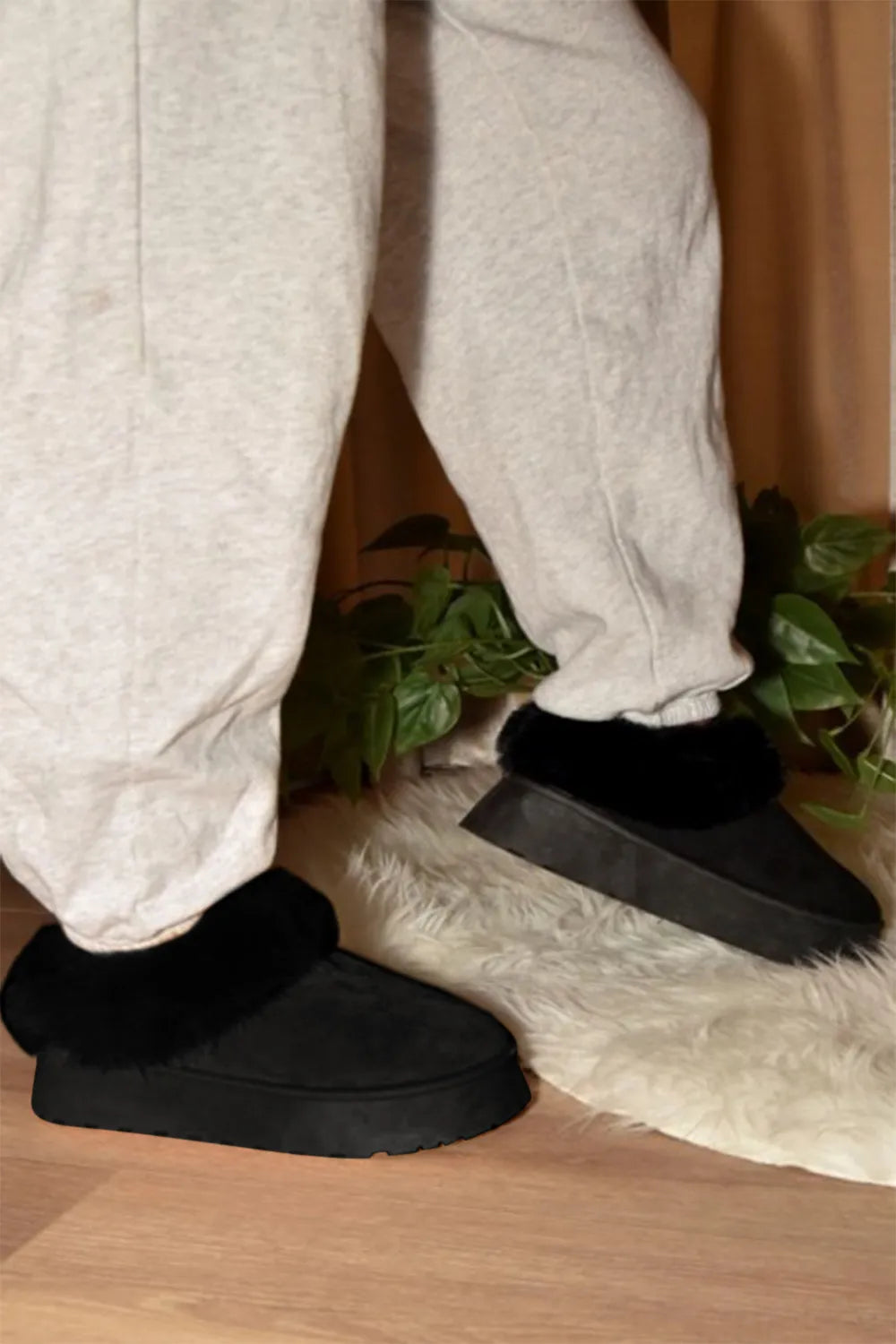 Black WILD DIVA faux-fur platform slip-on booties by Trendsi, featuring a plush fur upper and chunky sole for stylish comfort.