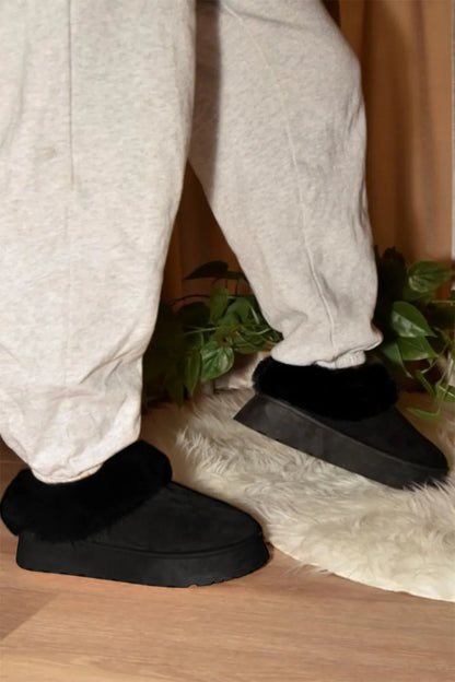 Black WILD DIVA faux-fur platform slip-on booties by Trendsi, featuring a plush fur upper and chunky sole for stylish comfort.