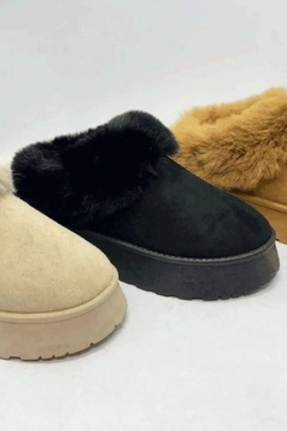 Black WILD DIVA Faux-Fur Platform Slip-On Booties by Trendsi showing the slip-on design with plush faux-fur detail and chunky platform sole.