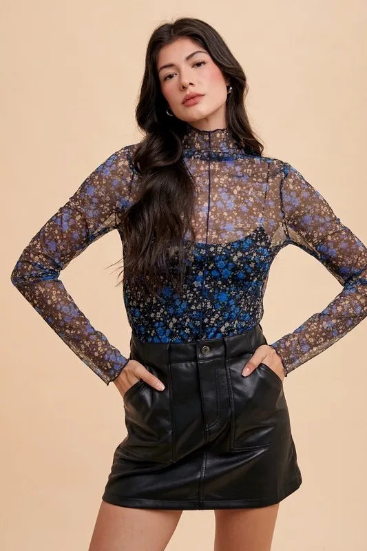 Black and blue floral sheer mesh top with lettuce hem by Annie Wear, featuring a lightweight, stylish design.